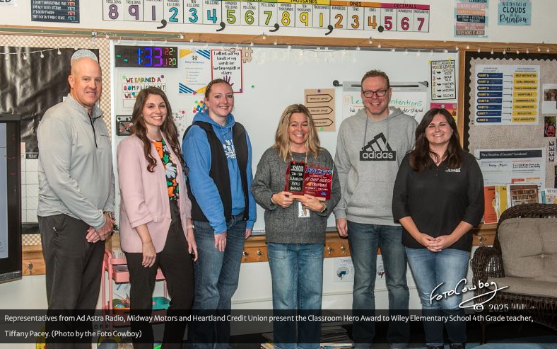 Representatives from Ad Astra Radio, Midway Motors and Heartland Credit Union present the Classroom Hero Award to Wiley Elementary School 4th Grade teacher, Tiffany Pacey. (Photo by the Foto Cowboy)