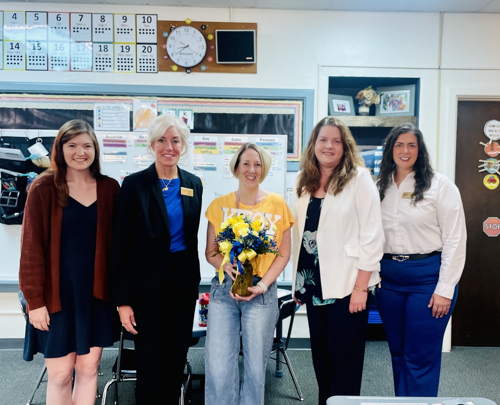 Tara Urban stands with District Leaders as she receives notification of her Kansas Teacher of the Year recognition