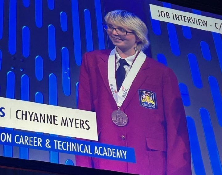 Chyanne Myers on stage with her medal.