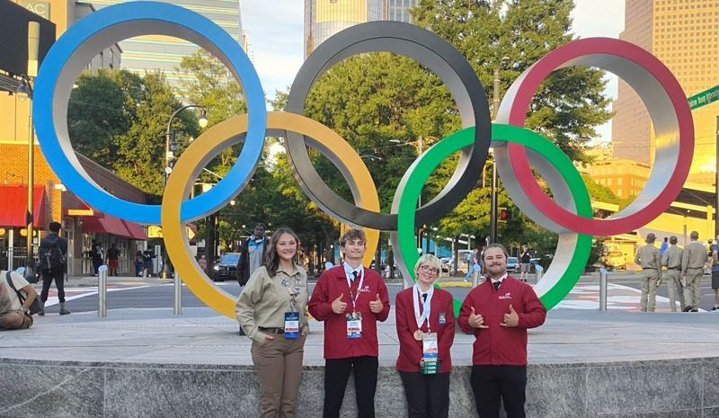 Left to Right: Harlie Terrell, Tanner Loushrie, Chyanne Myers, and Blake Beaumont in front of Olympic Park Rings. Atlanta, GA