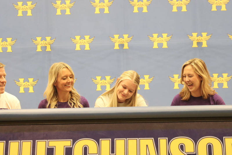 Myky Thompson (center), signs her letter of intent. On her right is her mother, Abby Thompson, and on the left is Coach Josie Armstrong