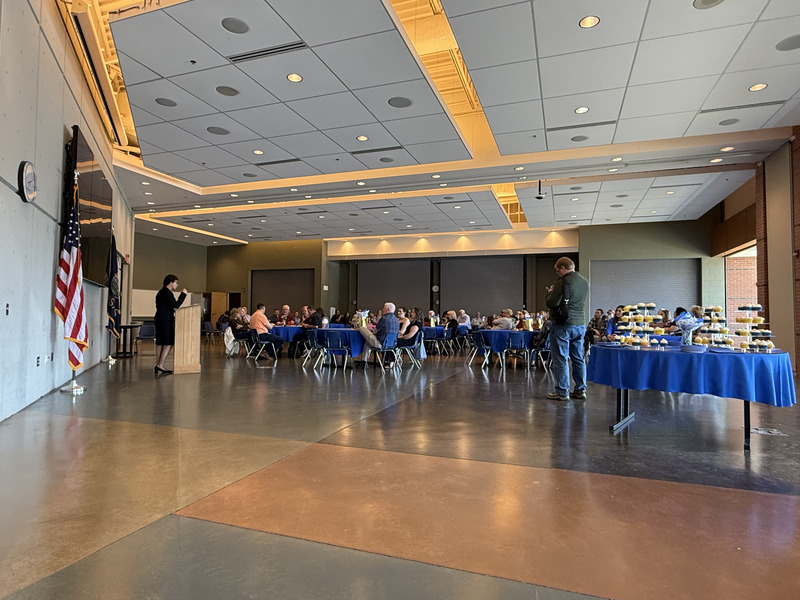 large room with tables and a speaker