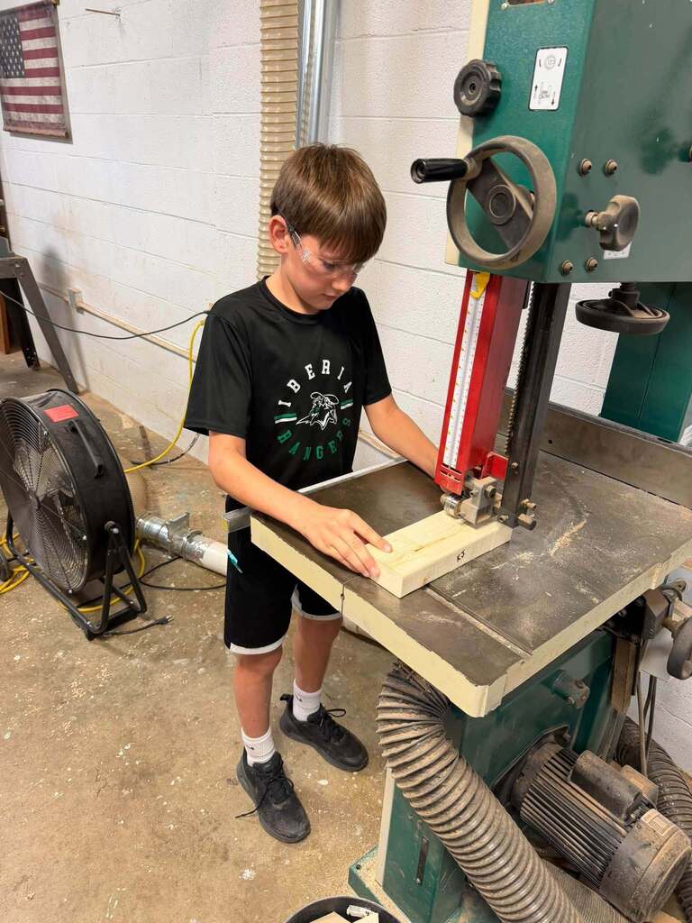 Junior High Ag. has been busy learning to work with some of the machines in the shop.  The past week they have been using the bandsaw, miter saw, table saw, drills and sanders.   The best part of Friday was watching the kids line up to take the picture! 