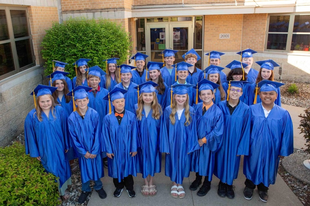 -students in caps and gowns smiling