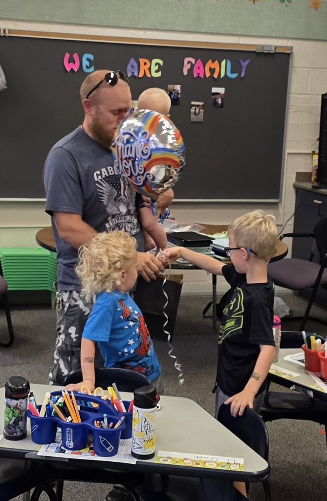 kids giving man a gift