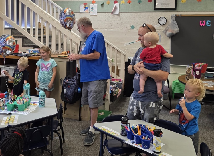 kids giving man a gift