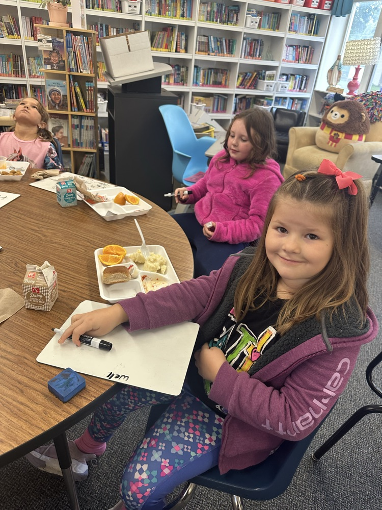 kids eating and writing