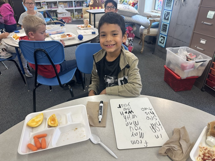 kids eating and writing