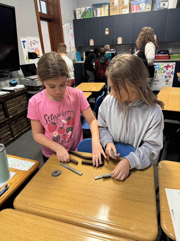 two children working with magnets