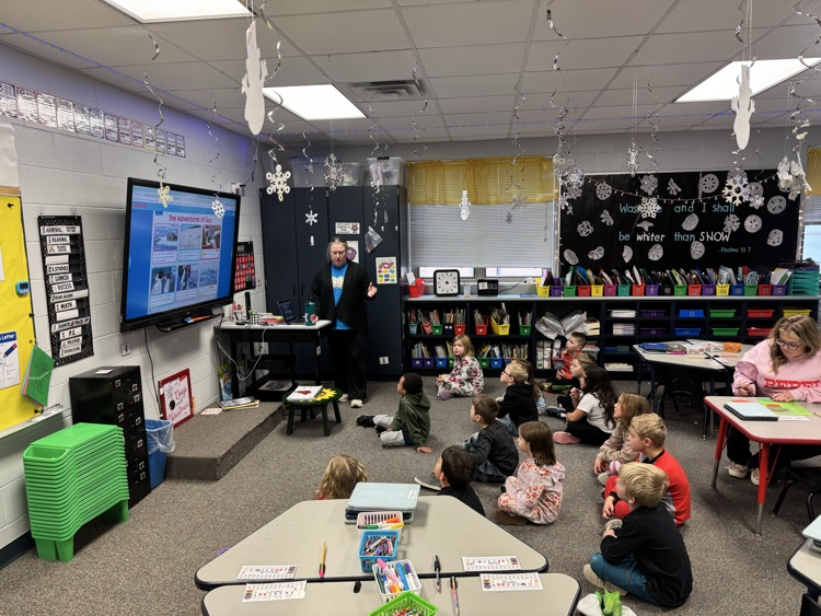 students on floor learning with teacher