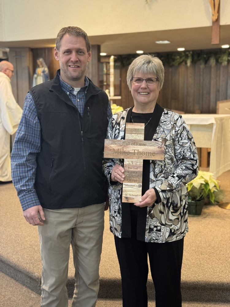 mother and son holding a cross