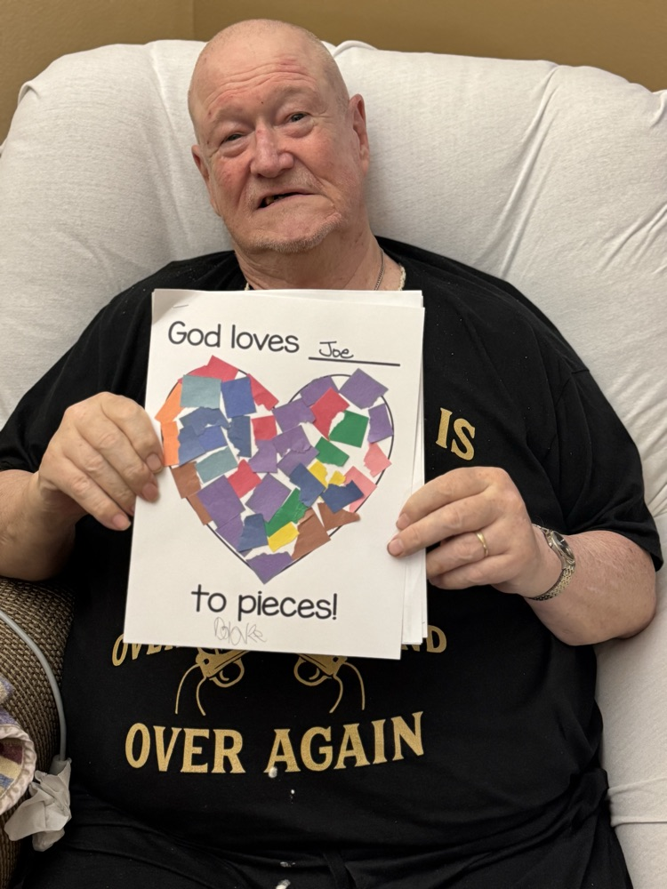 old man holding card