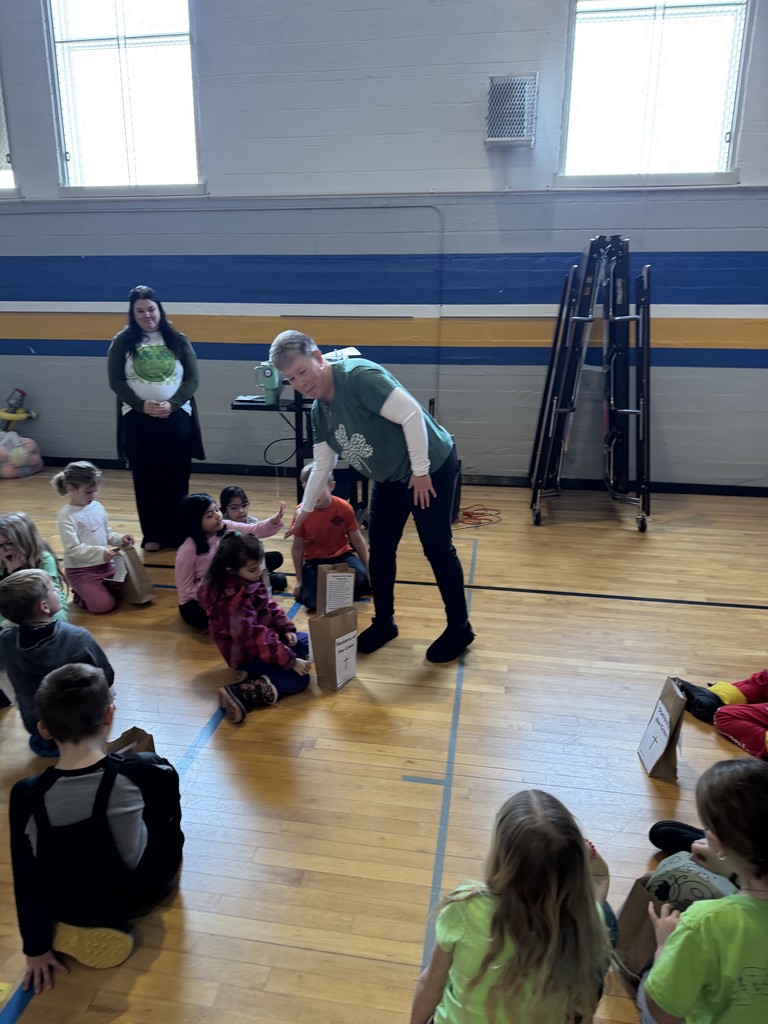 woman in green shirt giving student high five