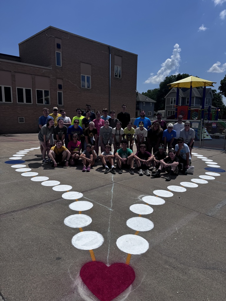 A group standing in the middle of a giant painted rosary