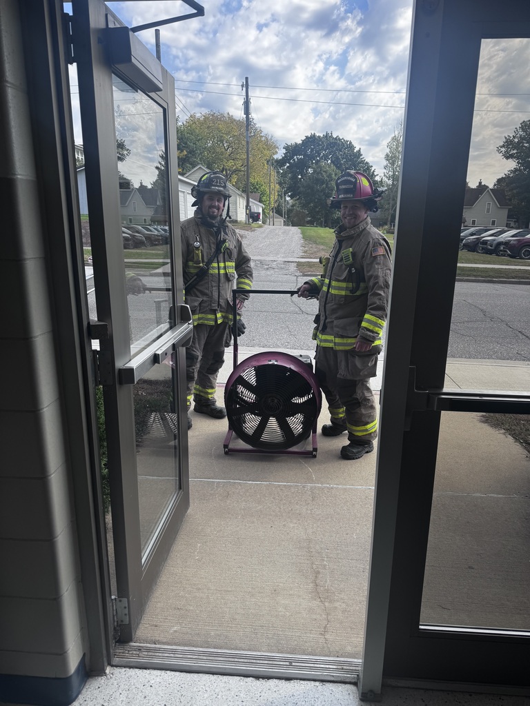firemen with a large fan by a door