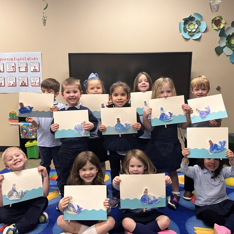 the pre-k 4 class smiling and holding up their completed Religion Craft 