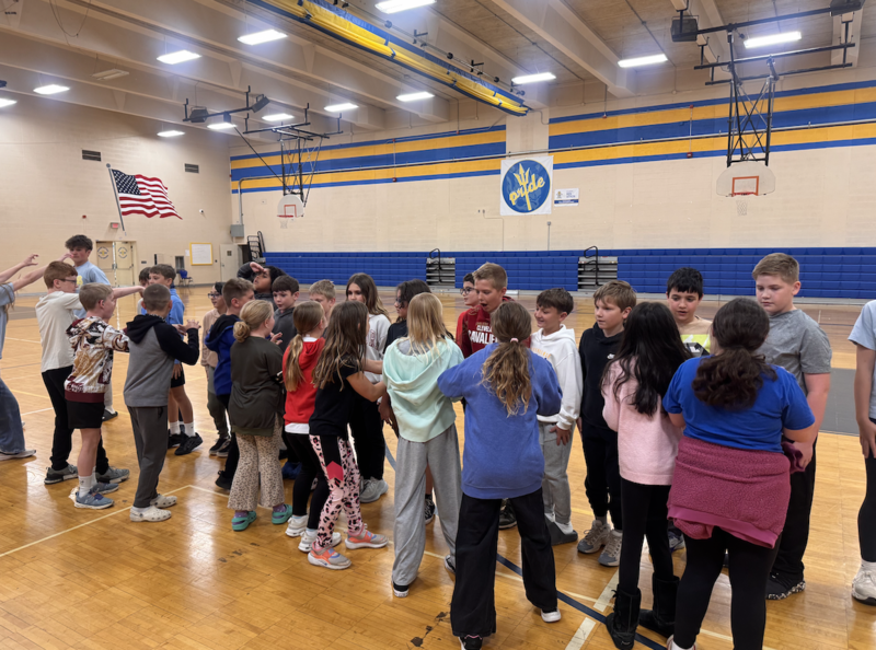 middle school students welcome primary school fourth graders for preview day