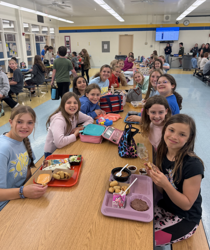 middle school students welcome primary school fourth graders for preview day