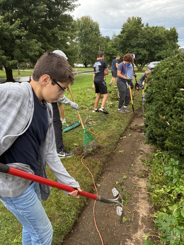 workers cleaning up yard