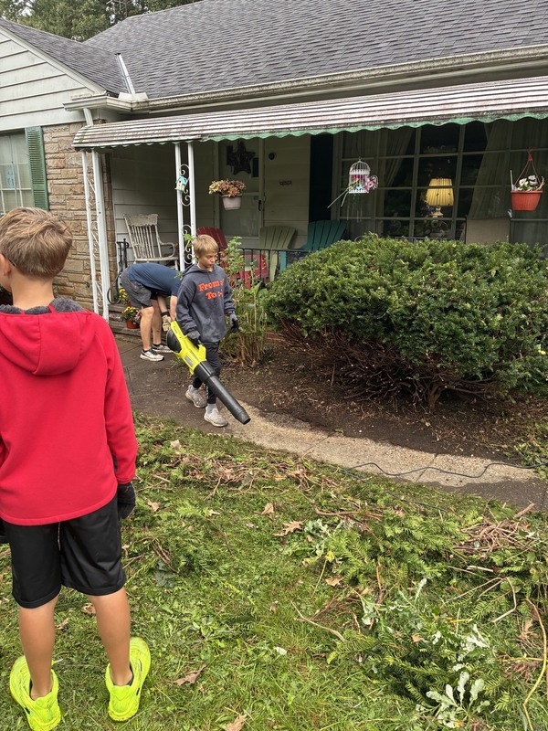 workers cleaning up yard