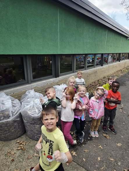 Pre-K Students cleaning the  Outdoor Learning Space!