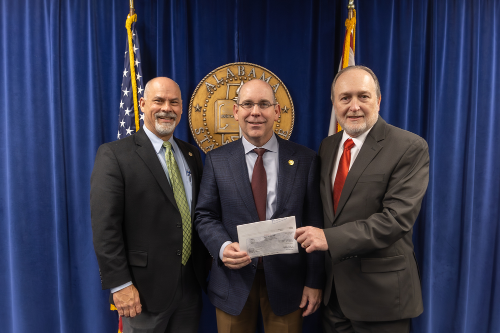 Chamliss presenting a check to Commissioner Hamm and David Walters