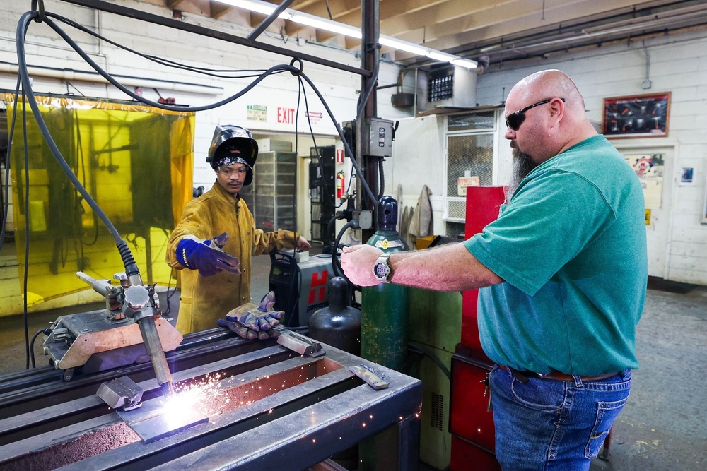 Welding instructor with student