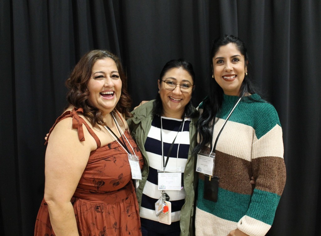 Three educators pose for a photo