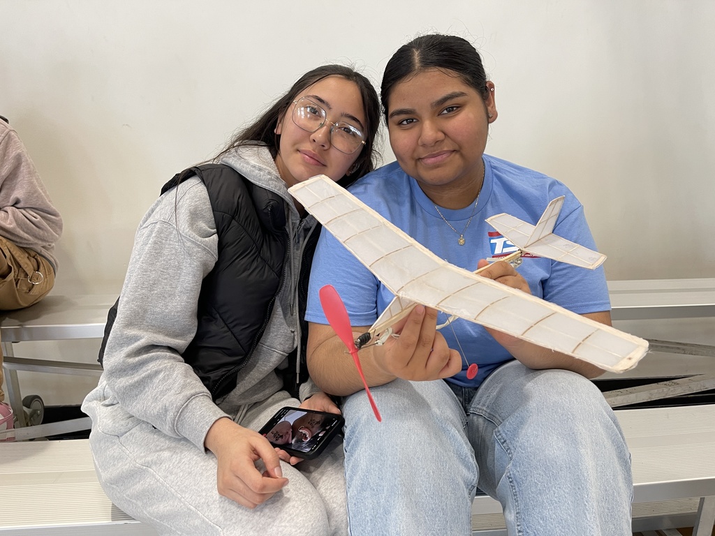 students pose with model plane