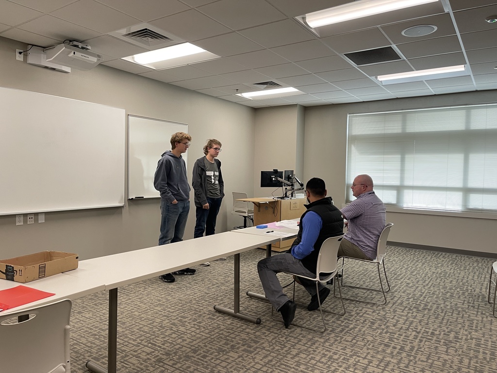 students discuss their project with judges