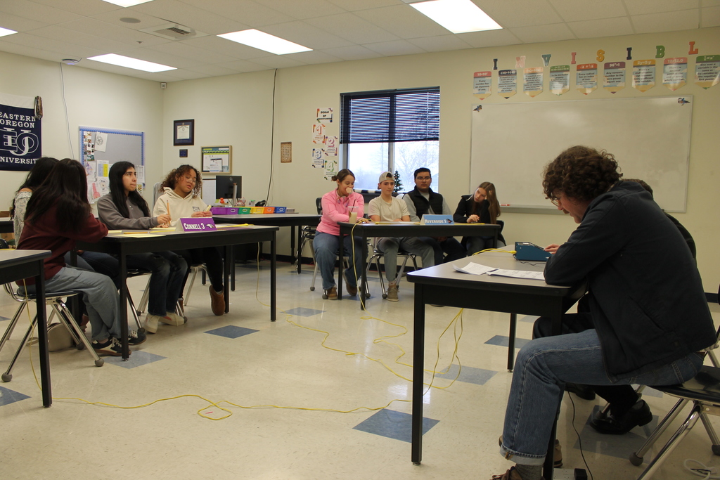 Participants wait as scorer reads a question