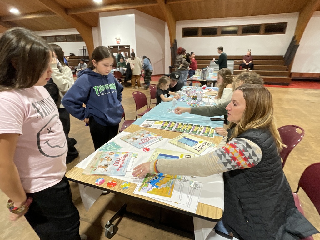 children at table with books
