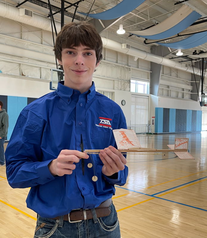 A student holds his model plane