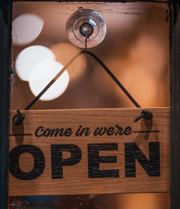 An open sign hanging in a doorway.