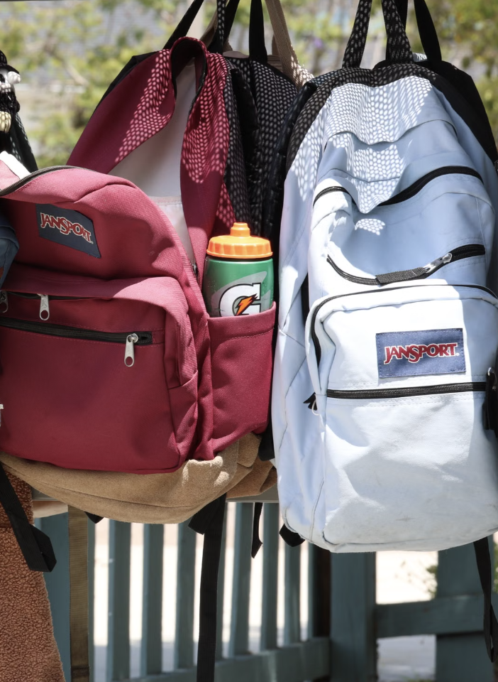 Backpacks hang filled with supplies.