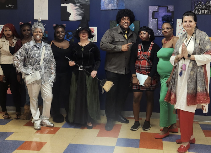 East campus staff and students smile in costumes for Costume Day