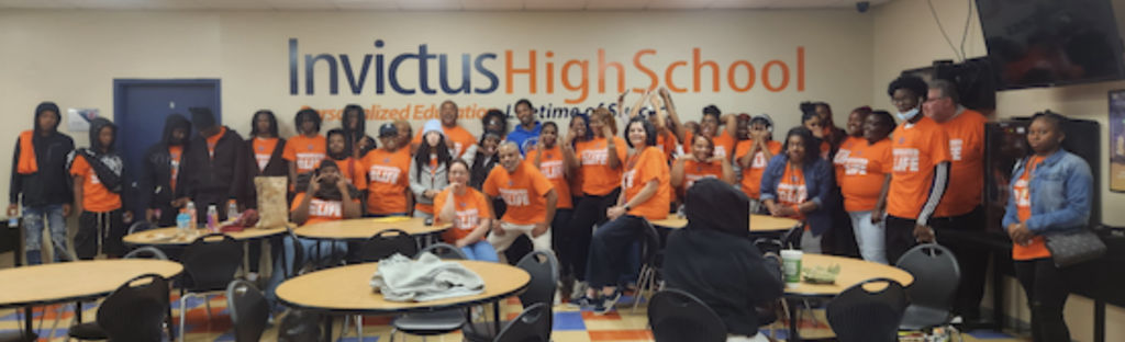 A group of Invictus students and staff wearing Invictus Gear