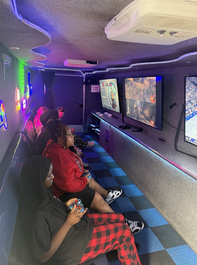 Students competing at video games on a gaming truck.