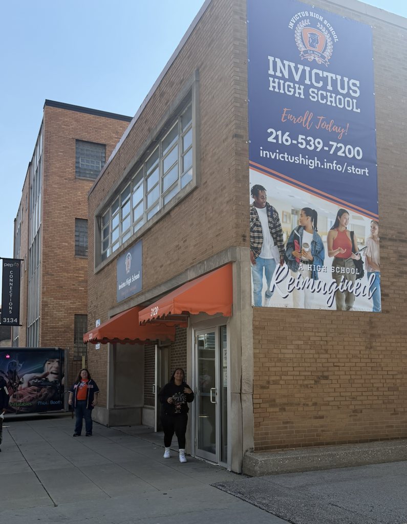 A student and staff member stand outside the downtown campus.