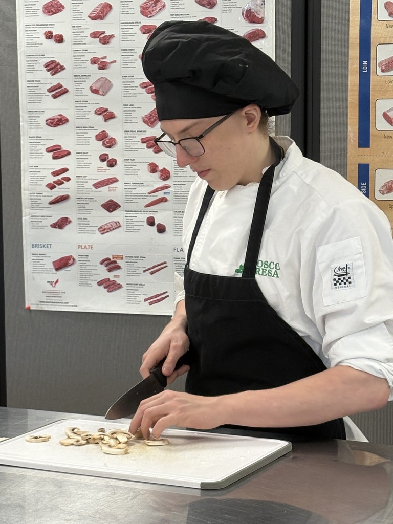 culinary student demonstrating knife cuts