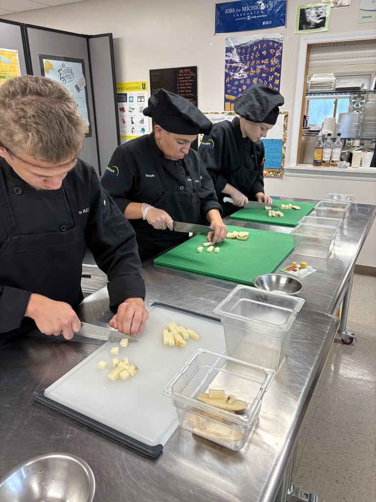 culinary student demonstrating knife cuts
