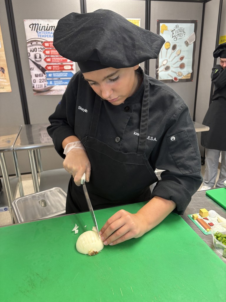 culinary student demonstrating knife cuts