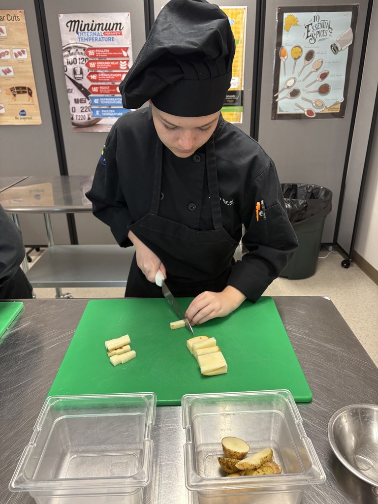 culinary student demonstrating knife cuts