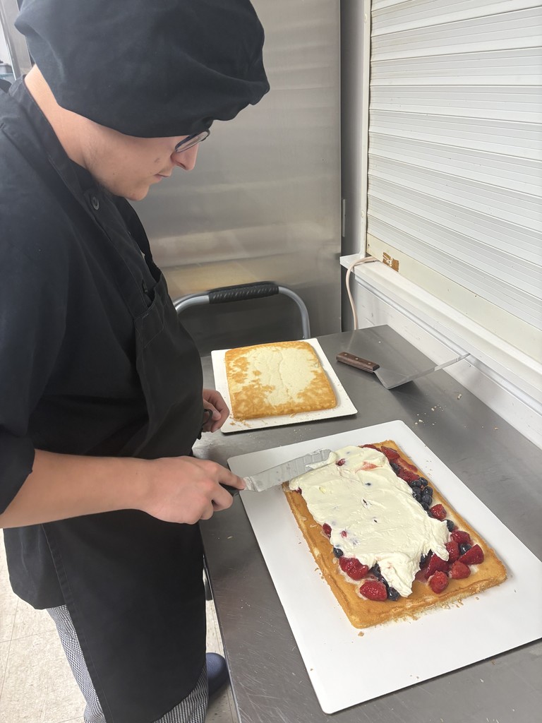 Student decorating cake