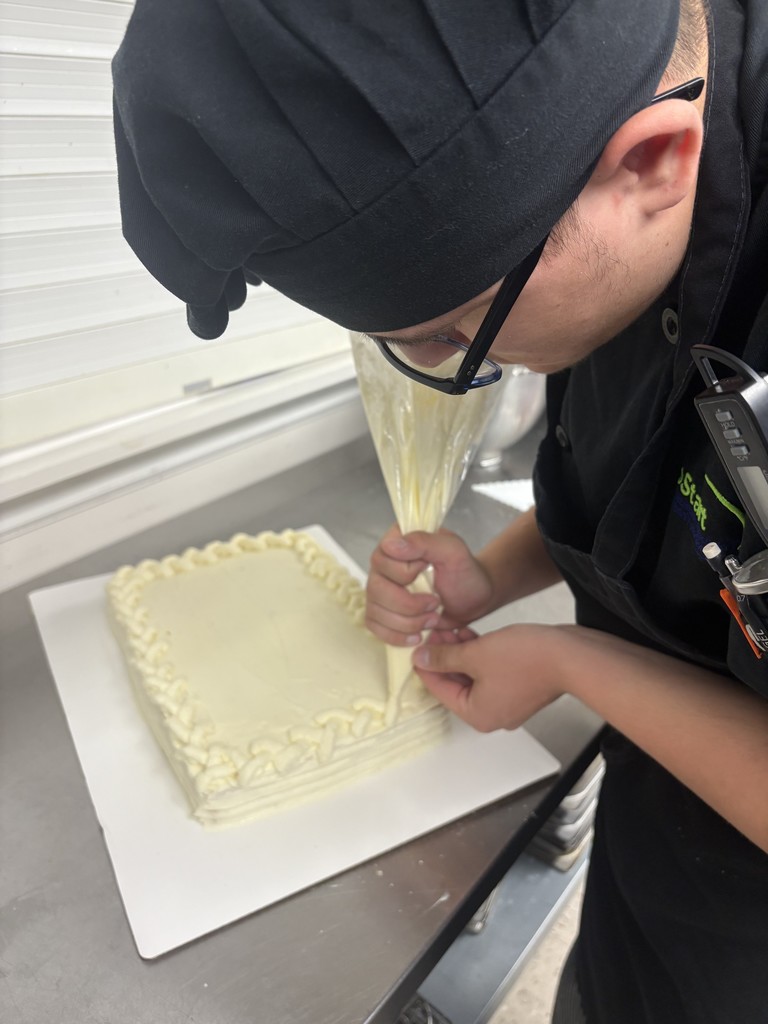 Student decorating cake