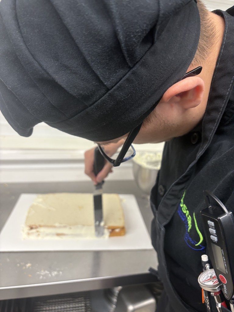 Student decorating cake