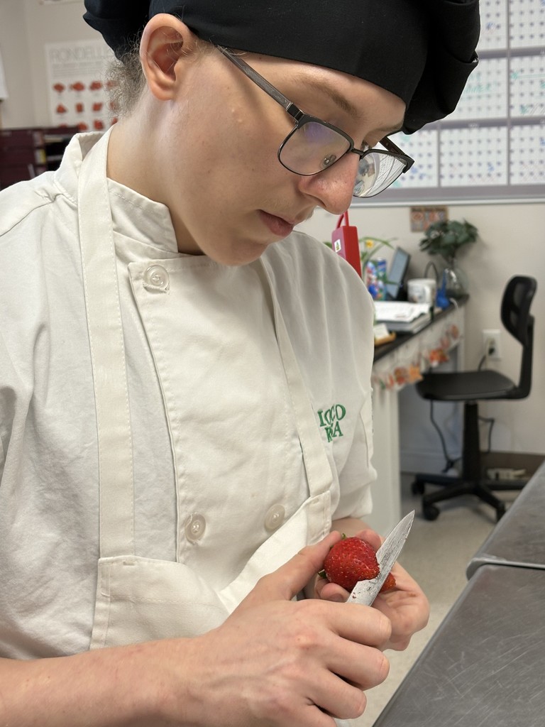 student working on dessert plating