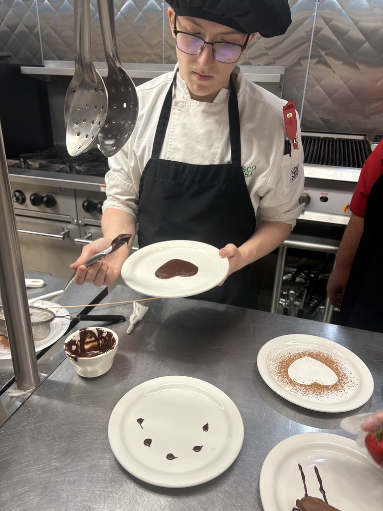 student working on dessert plating