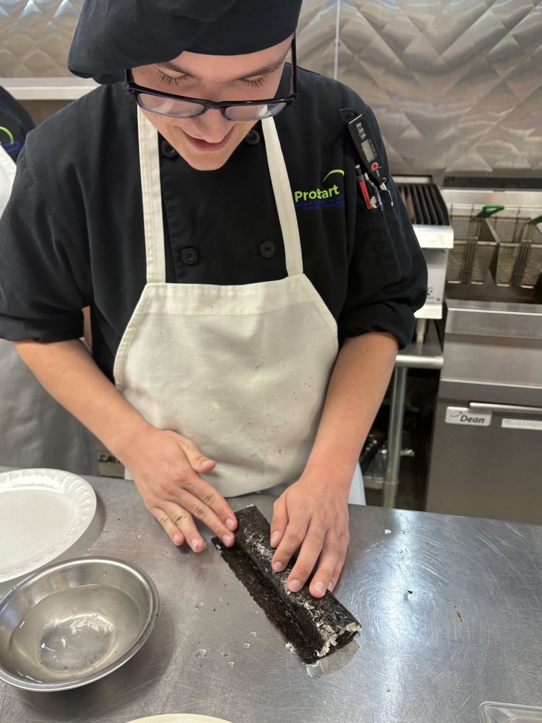 student preparing sushi