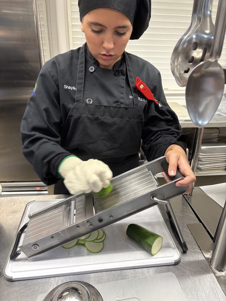student using slicer to slice zucchini